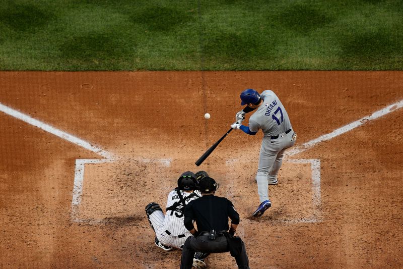 Jun 18, 2024; Denver, Colorado, USA; Los Angeles Dodgers designated hitter Shohei Ohtani (17) hits a solo home run in the sixth inning against the Colorado Rockies at Coors Field. Mandatory Credit: Isaiah J. Downing-USA TODAY Sports