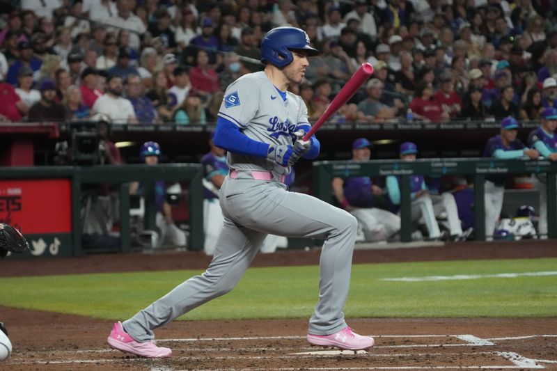 May 11, 2025; Phoenix, Arizona, USA; Los Angeles Dodgers first base Freddie Freeman (5) hits a double against the Arizona Diamondbacks in the third inning at Chase Field. Mandatory Credit: Rick Scuteri-Imagn Images