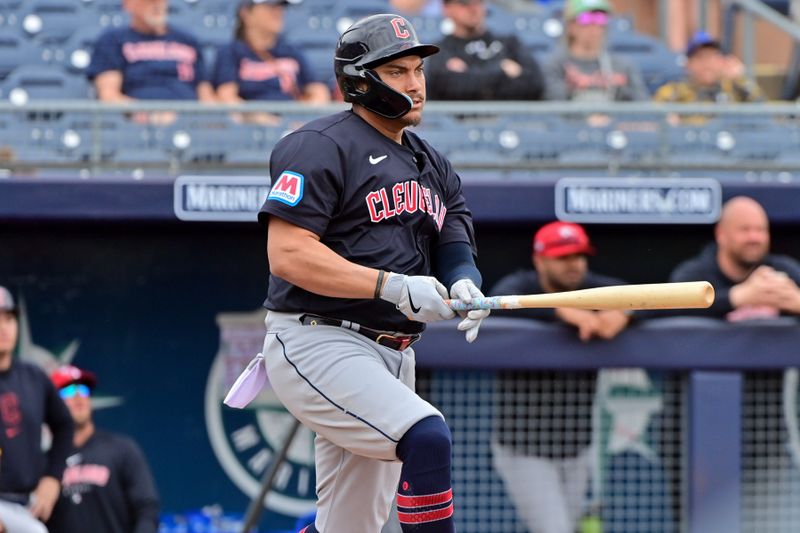 Feb 26, 2024; Peoria, Arizona, USA;  Cleveland Guardians first baseman Josh Naylor (22)  hits a 2 RBI single in the first inning against the San Diego Padres during a spring training game at Peoria Sports Complex. Mandatory Credit: Matt Kartozian-USA TODAY Sports