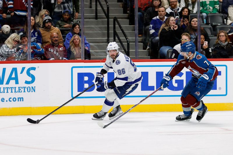 Oct 30, 2024; Denver, Colorado, USA; Tampa Bay Lightning right wing Nikita Kucherov (86) controls the puck as Colorado Avalanche defenseman Devon Toews (7) defends in the first period at Ball Arena. Mandatory Credit: Isaiah J. Downing-Imagn Images