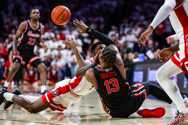 Feb 15, 2025; Tucson, Arizona, USA; Arizona Wildcats guard KJ Lewis (5) attempts to block Houston Cougars forward J’Wan Roberts (13) on the floor during the second half at McKale Center. Mandatory Credit: Aryanna Frank-Imagn Images