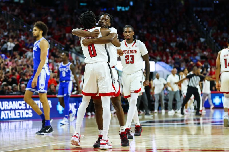 Jan 4, 2023; Raleigh, North Carolina, USA;  North Carolina State Wolfpack guard Terquavion Smith (0) and guard Jarkel Joiner (1) embrace to celebrate during the first half against Duke Blue Devils at PNC Arena. Mandatory Credit: Jaylynn Nash-USA TODAY Sports