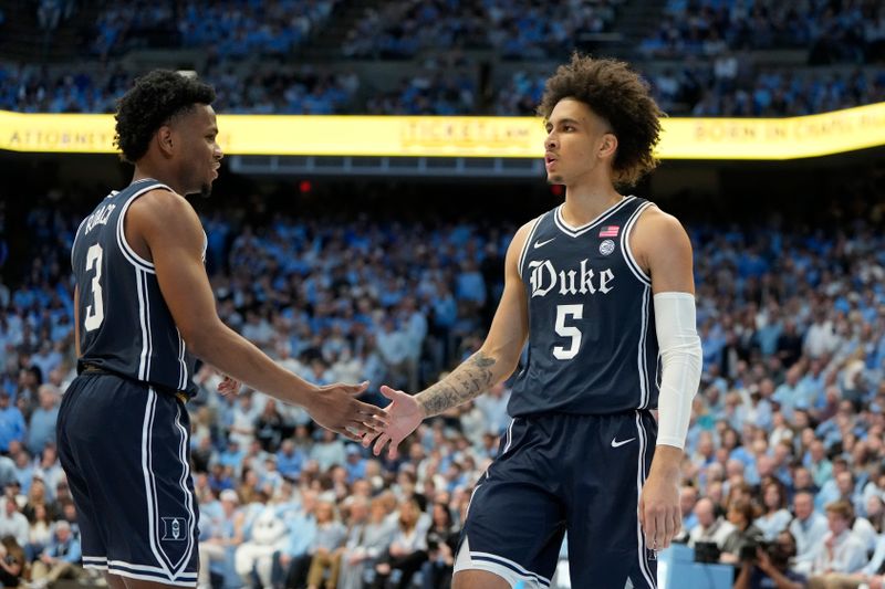 Feb 3, 2024; Chapel Hill, North Carolina, USA;  Duke Blue Devils guard Jeremy Roach (3) reacts with guard Tyrese Proctor (5) in the first half at Dean E. Smith Center. Mandatory Credit: Bob Donnan-USA TODAY Sports