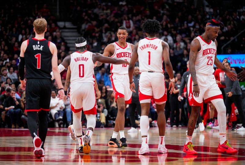 TORONTO, ON - FEBRUARY 9: Jabari Smith #10, Aaron Holiday #0, Amen Thompson #1 and Reggie Bullock #25 of the Houston Rockets celebrates against the Toronto Raptors during the second half of their basketball game at the Scotiabank Arena on February 9, 2024 in Toronto, Ontario, Canada. NOTE TO USER: User expressly acknowledges and agrees that, by downloading and/or using this Photograph, user is consenting to the terms and conditions of the Getty Images License Agreement. (Photo by Mark Blinch/Getty Images)