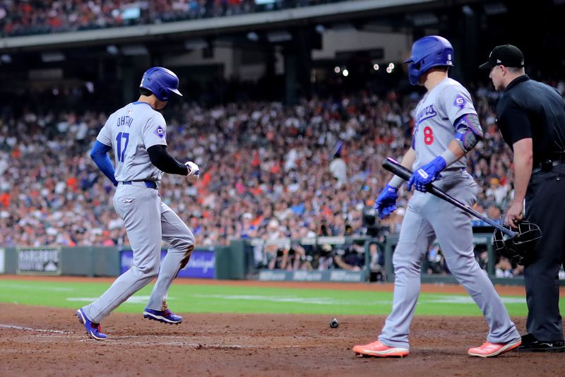 Jul 28, 2024; Houston, Texas, USA; Los Angeles Dodgers designated hitter Shohei Ohtani (17) crosses home plate to score a run against the Houston Astros at Minute Maid Park. Mandatory Credit: Erik Williams-USA TODAY Sports