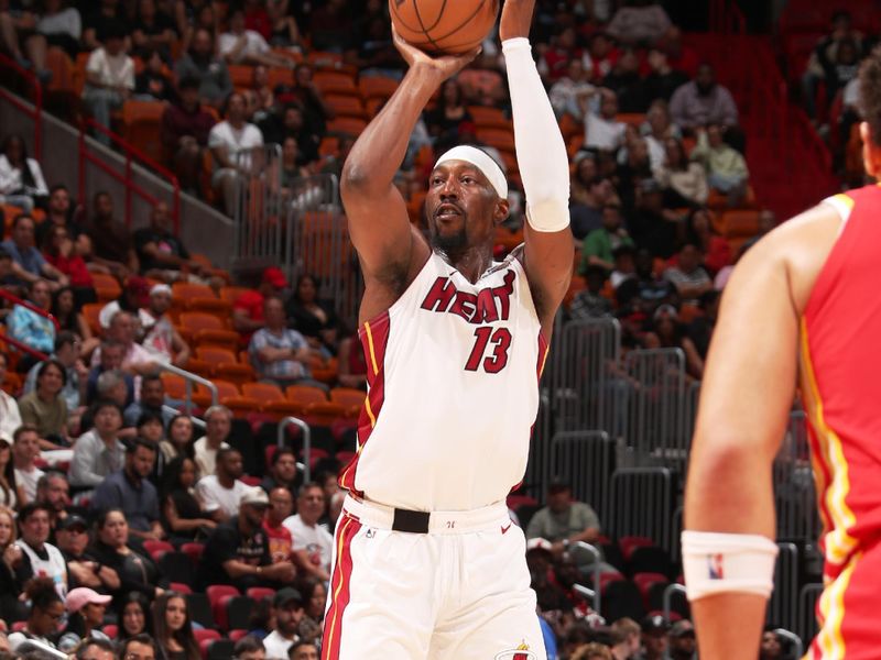 MIAMI, FL - OCTOBER 16: Bam Adebayo #13 of the Miami Heat shots a three point basket at the game against the Atlanta Hawks on October 16, 2024 at Miami-Dade Arena in Miami, Florida. NOTE TO USER: User expressly acknowledges and agrees that, by downloading and or using this Photograph, user is consenting to the terms and conditions of the Getty Images License Agreement. Mandatory Copyright Notice: Copyright 2024 NBAE (Photo by Issac Baldizon/NBAE via Getty Images)