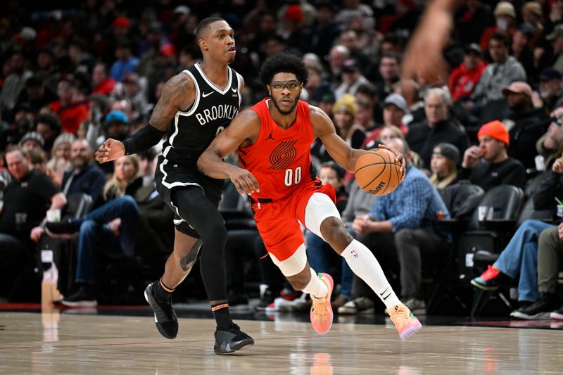 PORTLAND, OREGON - JANUARY 17: Scoot Henderson #00 of the Portland Trail Blazers brings the ball up court against Lonnie Walker IV #8 of the Brooklyn Nets during the third quarter at the Moda Center on January 17, 2024 in Portland, Oregon. The Portland Trail Blazers won 105-103. NOTE TO USER: User expressly acknowledges and agrees that, by downloading and or using this photograph, User is consenting to the terms and conditions of the Getty Images License Agreement. (Photo by Alika Jenner/Getty Images)