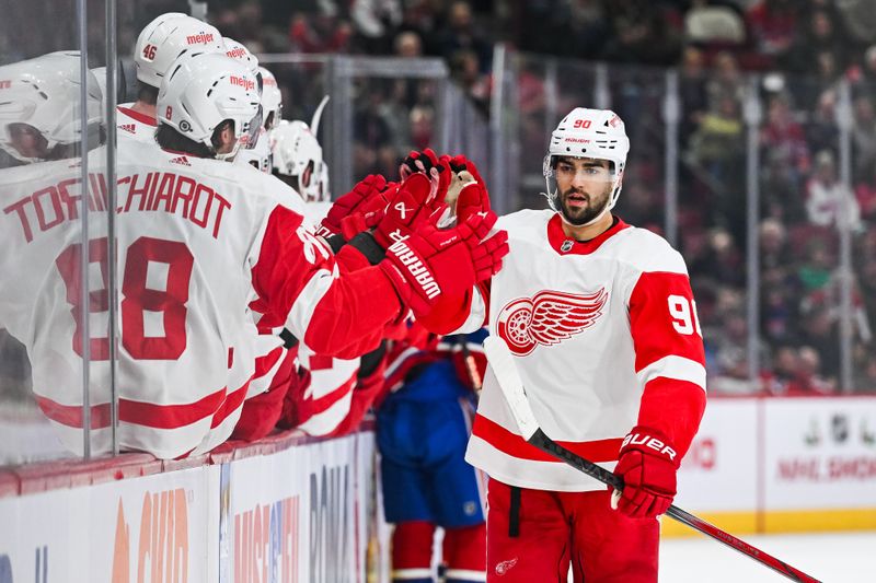 Dec 2, 2023; Montreal, Quebec, CAN; Detroit Red Wings center Joe Veleno (90) celebrates his goal against the Montreal Canadiens with his teammates at the bench during the first period at Bell Centre. Mandatory Credit: David Kirouac-USA TODAY Sports