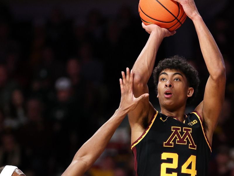 Feb 6, 2024; Minneapolis, Minnesota, USA; Minnesota Golden Gophers guard Cam Christie (24) shoots as Michigan State Spartans guard Tre Holloman (5) defends during the first half at Williams Arena. Mandatory Credit: Matt Krohn-USA TODAY Sports