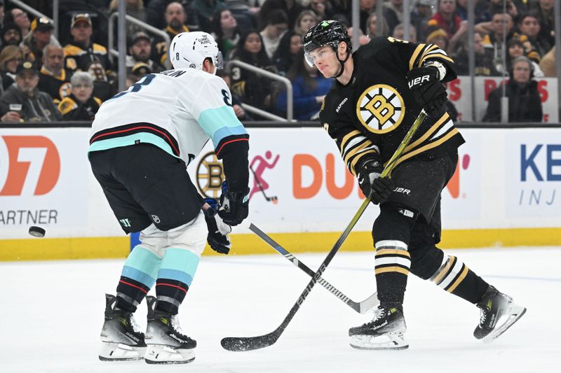 Feb 15, 2024; Boston, Massachusetts, USA;  Boston Bruins center Morgan Geekie (39) passes the puck past Seattle Kraken defenseman Brian Dumoulin (8) during the third period at the TD Garden. Mandatory Credit: Brian Fluharty-USA TODAY Sports