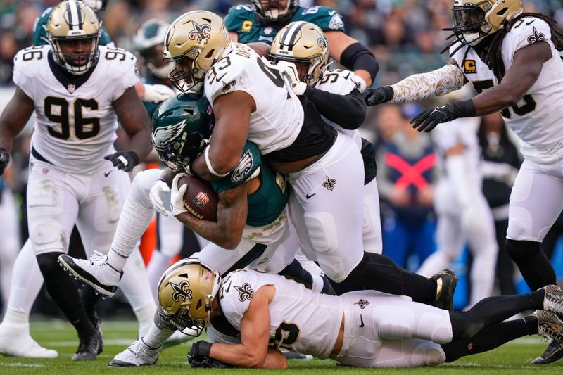 Philadelphia Eagles running back Miles Sanders is stopped by New Orleans Saints defensive tackle David Onyemata in the second half of an NFL football game in Philadelphia, Sunday, Jan. 1, 2023. (AP Photo/Matt Rourke)