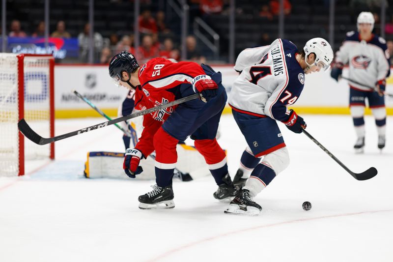 Sep 27, 2024; Washington, District of Columbia, USA; Washington Capitals Henrik Rybinski (58) and Columbus Blue Jackets defenseman Corson Ceulemans (74) battle for the puck in the third period at Capital One Arena. Mandatory Credit: Geoff Burke-Imagn Images