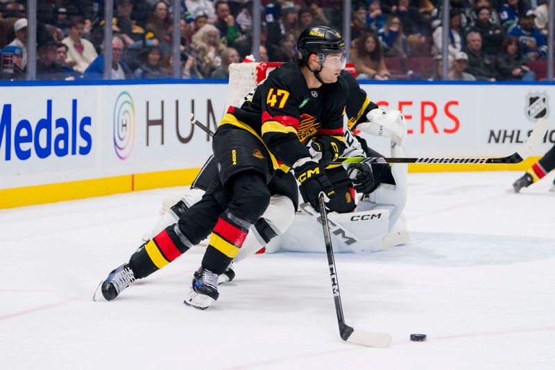 Feb 29, 2024; Vancouver, British Columbia, CAN; Vancouver Canucks defenseman Noah Juulsen (47) handles the puck against the Los Angeles Kings in the third period at Rogers Arena. Kings won 5-1. Mandatory Credit: Bob Frid-USA TODAY Sports