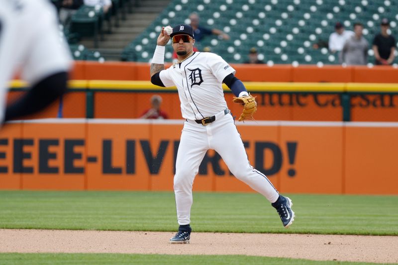 Apr 17, 2024; Detroit, Michigan, USA; Detroit Tigers shortstop Javier Báez (28) throws to first during the ninth inning against the Texas Rangers at Comerica Park. Mandatory Credit: Brian Bradshaw Sevald-USA TODAY Sports