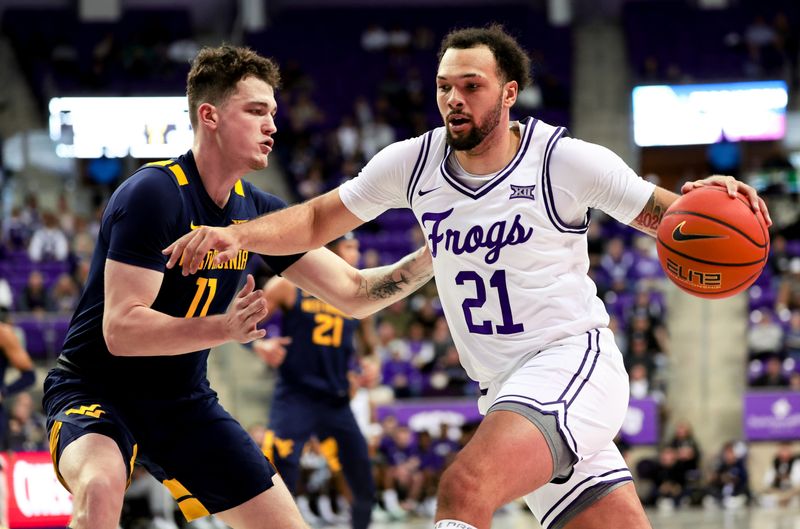 Feb 12, 2024; Fort Worth, Texas, USA;  TCU Horned Frogs forward JaKobe Coles (21) drives to the basket as West Virginia Mountaineers forward Quinn Slazinski (11) defends during the first half at Ed and Rae Schollmaier Arena. Mandatory Credit: Kevin Jairaj-USA TODAY Sports