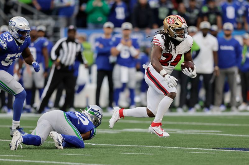 San Francisco 49ers running back Jordan Mason (24) runs during the first half of an NFL football game against the Seattle Seahawks, Thursday, Oct. 10, 2024, in Seattle. (AP Photo/John Froschauer)