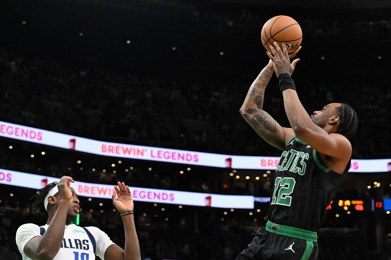 BOSTON, MASSACHUSETTS - MARCH 01: Oshae Brissett #12 of the Boston Celtics attempts a basket past Tim Hardaway Jr. #10 of the Dallas Mavericks during the fourth quarter at the TD Garden on March 01, 2024 in Boston, Massachusetts. NOTE TO USER: User expressly acknowledges and agrees that, by downloading and or using this photograph, User is consenting to the terms and conditions of the Getty Images License Agreement. (Photo by Brian Fluharty/Getty Images)