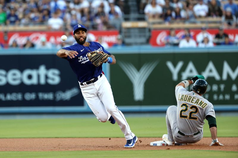 Aug 3, 2023; Los Angeles, California, USA;  Oakland Athletics right fielder Ramon Laureano (22) is out at second as Los Angeles Dodgers second baseman Amed Rosario (31) throws to first to complete a double play in the first inning at Dodger Stadium. Mandatory Credit: Kiyoshi Mio-USA TODAY Sports