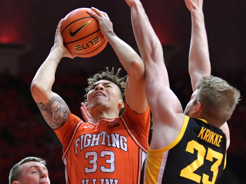 Feb 24, 2024; Champaign, Illinois, USA;  Illinois Fighting Illini forward Coleman Hawkins (33) drives to the basket as Iowa Hawkeyes forward Ben Krikke (23) defends during the first half at State Farm Center. Mandatory Credit: Ron Johnson-USA TODAY Sports