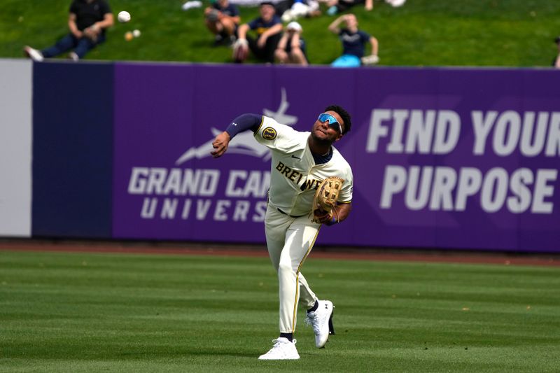 Mar 18, 2024; Phoenix, Arizona, USA; Milwaukee Brewers right fielder Jackson Chourio (11) makes the play against the Los Angeles Angels in the second inning at American Family Fields of Phoenix. Mandatory Credit: Rick Scuteri-USA TODAY Sports