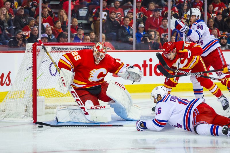 Oct 24, 2023; Calgary, Alberta, CAN; New York Rangers center Vincent Trocheck (16) controls the puck in front of Calgary Flames goaltender Jacob Markstrom (25) during the third period at Scotiabank Saddledome. Mandatory Credit: Sergei Belski-USA TODAY Sports