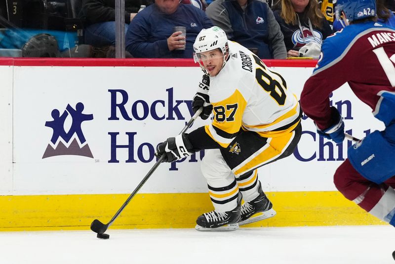 Mar 24, 2024; Denver, Colorado, USA; Pittsburgh Penguins center Sidney Crosby (87) controls the puck in the first period against the Colorado Avalanche at Ball Arena. Mandatory Credit: Ron Chenoy-USA TODAY Sports