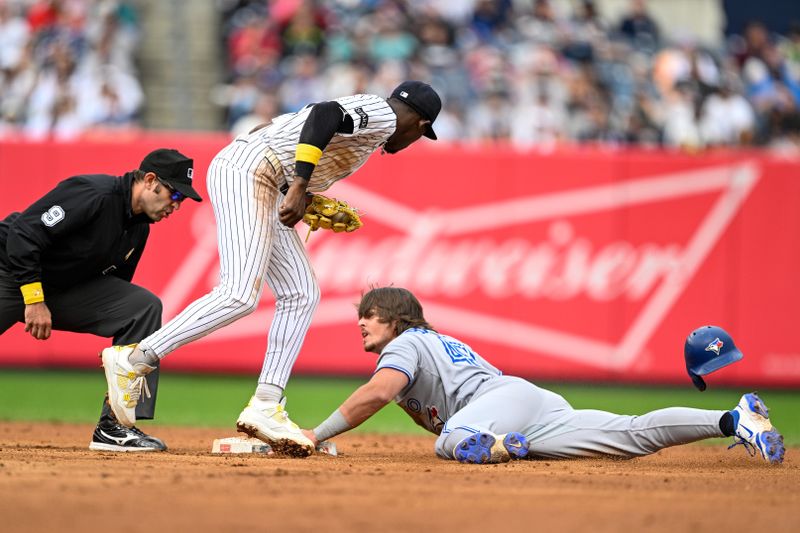 Sep 7, 2025; Bronx, New York, USA; Toronto Blue Jays third baseman Addison Barger (47) slides to steal 2nd base against New York Yankees second baseman Jazz Chisholm Jr. (13) at Yankee Stadium. Mandatory Credit: Mark Smith-Imagn Images