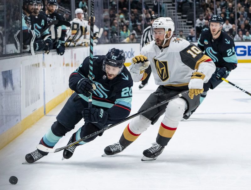 Mar 12, 2024; Seattle, Washington, USA; Seattle Kraken forward Oliver Bjorkstrand (22) and Vegas Golden Knights forward Nicolas Roy (10) battle for the puck during overtime at Climate Pledge Arena. Mandatory Credit: Stephen Brashear-USA TODAY Sports