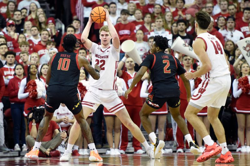 Dec 6, 2022; Madison, Wisconsin, USA;  Wisconsin Badgers forward Steven Crowl (22) looks to pass the ball under coverage by Maryland Terrapins forward Julian Reese (10) and Maryland Terrapins guard Jahari Long (2) during the first half at the Kohl Center. Mandatory Credit: Kayla Wolf-USA TODAY Sports