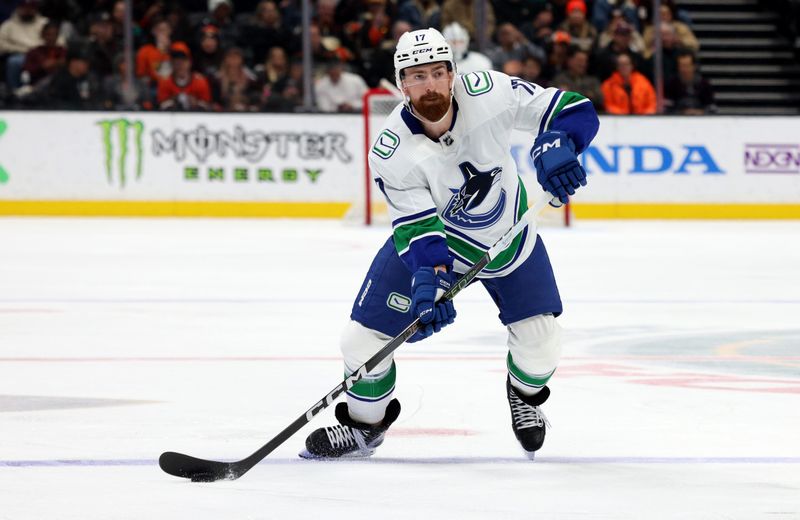 Mar 3, 2024; Anaheim, California, USA; Vancouver Canucks defenseman Filip Hronek (17) controls the puck during the third period against the Anaheim Ducks at Honda Center. Mandatory Credit: Jason Parkhurst-USA TODAY Sports