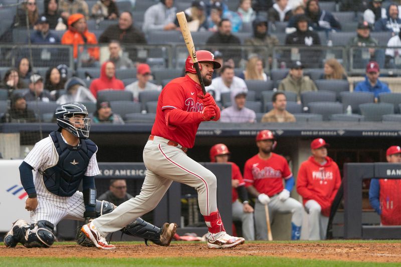 Apr 5, 2023; Bronx, New York, USA; Philadelphia Phillies left fielder Kyle Schwarber (12) hits a home run against the New York Yankees during the eighth inning at Yankee Stadium. Mandatory Credit: Gregory Fisher-USA TODAY Sports