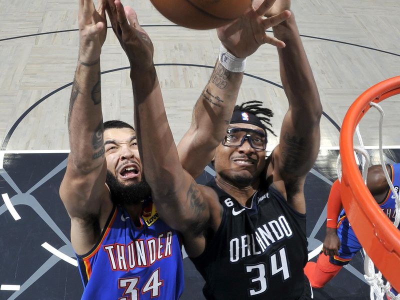 ORLANDO, FL - JANUARY 4: Kenrich Williams #34 of the Oklahoma City Thunder and Wendell Carter Jr. #34 of the Orlando Magic fight for the rebound during the game between the Oklahoma City Thunder and the Orlando Magic on January 4, 2023 at Amway Center in Orlando, Florida. NOTE TO USER: User expressly acknowledges and agrees that, by downloading and or using this photograph, User is consenting to the terms and conditions of the Getty Images License Agreement. Mandatory Copyright Notice: Copyright 2023 NBAE (Photo by Fernando Medina/NBAE via Getty Images)