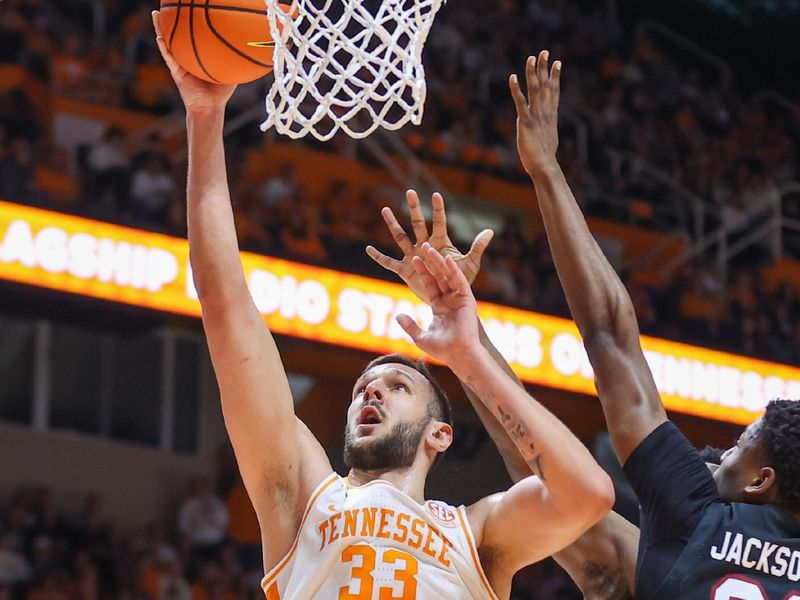 Feb 25, 2023; Knoxville, Tennessee, USA; Tennessee Volunteers forward Uros Plavsic (33) goes to the basket against South Carolina Gamecocks forward Gregory Jackson II (23) during the first half at Thompson-Boling Arena. Mandatory Credit: Randy Sartin-USA TODAY Sports