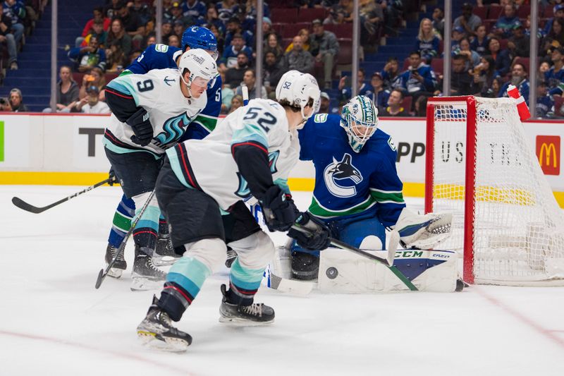 Sep 29, 2022;  Vancouver, British Columbia, CAN; Vancouver Canucks goalie Thatcher Demko (35) blocks a shot against Seattle Kraken forward Ryan Donato (9) in the first period at Rogers Arena. Mandatory Credit: Bob Frid-USA TODAY Sports