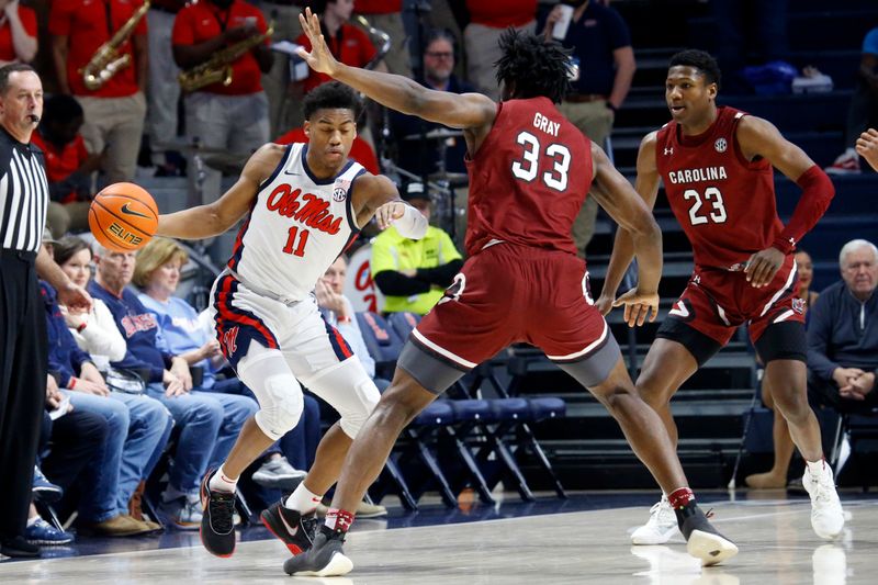 Feb 11, 2023; Oxford, Mississippi, USA; Mississippi Rebels guard Matthew Murrell (11) dribbles as South Carolina Gamecocks forward Josh Gray (33) and South Carolina Gamecocks forward Gregory \