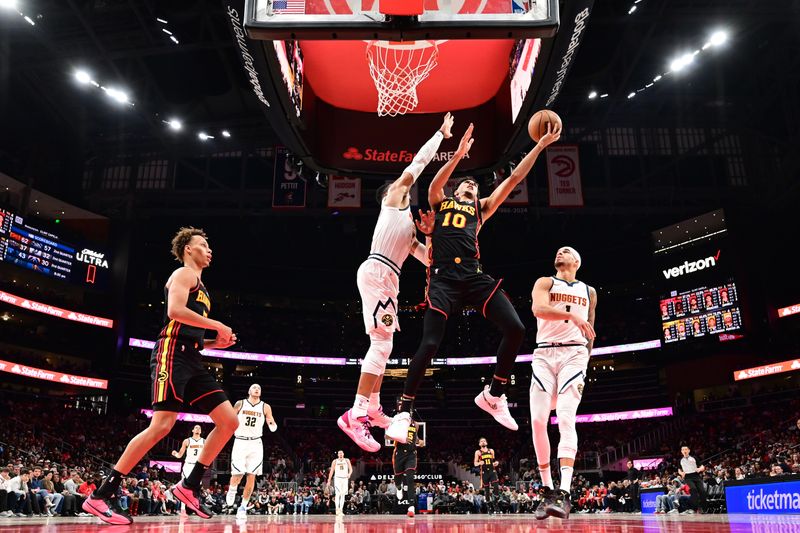 ATLANTA, GA - DECEMBER 8: Zaccharie Risacher #10 of the Atlanta Hawks drives to the basket during the game against the Denver Nuggets on December 8, 2024 at State Farm Arena in Atlanta, Georgia.  NOTE TO USER: User expressly acknowledges and agrees that, by downloading and/or using this Photograph, user is consenting to the terms and conditions of the Getty Images License Agreement. Mandatory Copyright Notice: Copyright 2024 NBAE (Photo by Adam Hagy/NBAE via Getty Images)