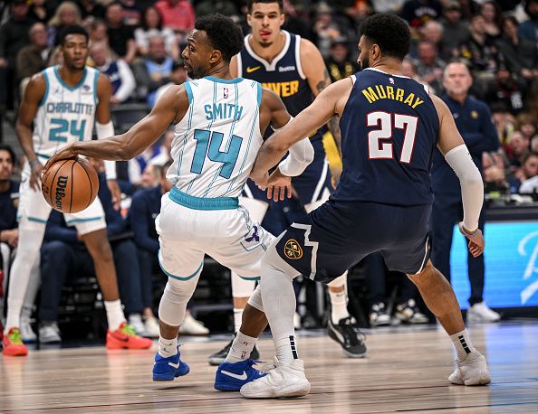 DENVER, CO - JANUARY 1: Ish Smith (14) of the Charlotte Hornets handles as Jamal Murray (27) of the Denver Nuggets defends during the first quarter at Ball Arena in Denver on Monday, January 1, 2024. (Photo by AAron Ontiveroz/The Denver Post)