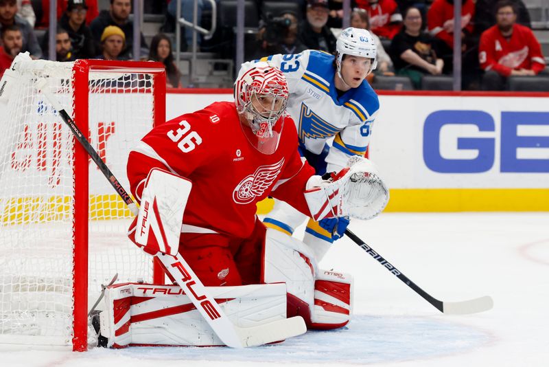 Oct 25, 2025; Detroit, Michigan, USA;  Detroit Red Wings goaltender John Gibson (36) tends goal in front of St. Louis Blues left wing Jake Neighbours (63) in the first period at Little Caesars Arena. Mandatory Credit: Rick Osentoski-Imagn Images