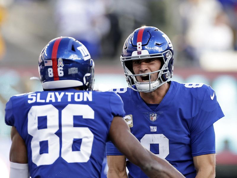 New York Giants quarterback Daniel Jones (8) reacts after throwing a touchdown pass to Darius Slayton against the Houston Texans during an NFL football game Sunday, Nov. 13, 2022, in East Rutherford, N.J. (AP Photo/Adam Hunger)