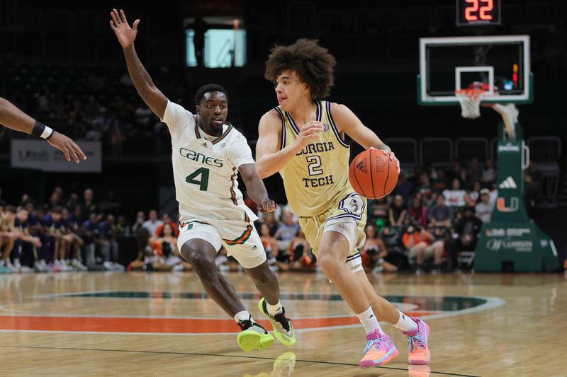 Feb 24, 2024; Coral Gables, Florida, USA; Georgia Tech Yellow Jackets guard Naithan George (2) drives to the basket past Miami Hurricanes guard Bensley Joseph (4) during the first half at Watsco Center. Mandatory Credit: Sam Navarro-USA TODAY Sports