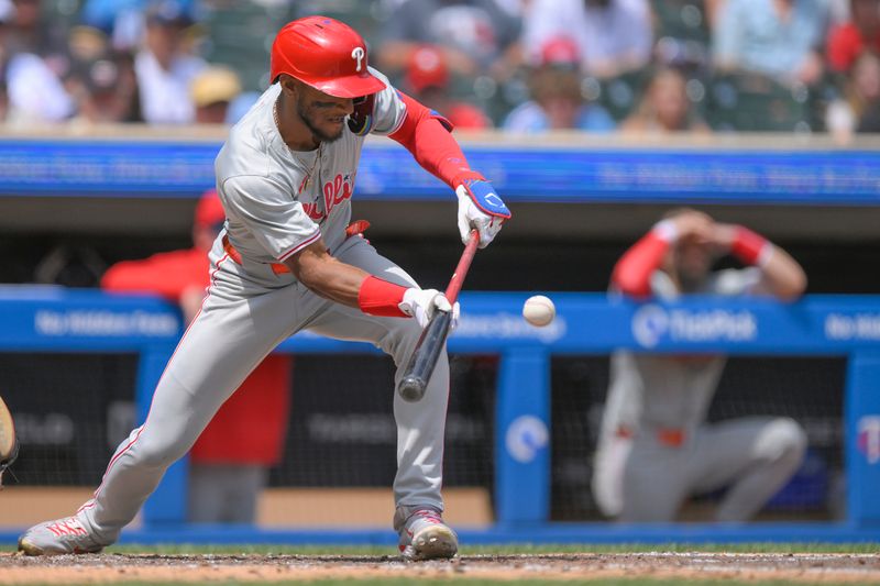 Jul 24, 2024; Minneapolis, Minnesota, USA;  Philadelphia Phillies outfielder Johan Rojas (18) lays down a sacrifice bunt against the Minnesota Twins during the sixth inning at Target Field. Mandatory Credit: Nick Wosika-USA TODAY Sports