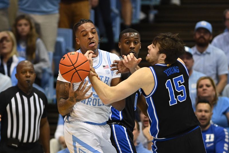 Mar 4, 2023; Chapel Hill, North Carolina, USA;  North Carolina Tar Heels forward Armando Bacot (5) and Duke Blue Devils center Ryan Young (15) fight for the ball in the first half at Dean E. Smith Center. Mandatory Credit: Bob Donnan-USA TODAY Sports