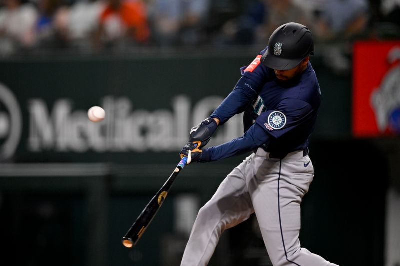 May 2, 2025; Arlington, Texas, USA; Seattle Mariners right fielder Rhylan Thomas (31) hits a sacrifice fly and drives in a run against the Texas Rangers during the fifth inning at Globe Life Field. Mandatory Credit: Jerome Miron-Imagn Images