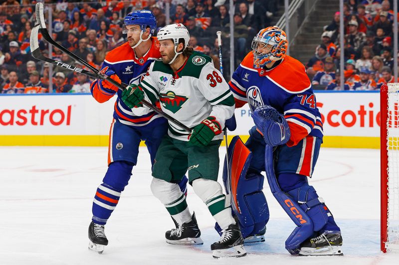 Nov 21, 2024; Edmonton, Alberta, CAN; Minnesota Wild forward Ryan Hartman (38) battles with Edmonton Oilers defensemen Josh Brown (44) in front of goaltender Stuart Skinner (74) during the second period at Rogers Place. Mandatory Credit: Perry Nelson-Imagn Images