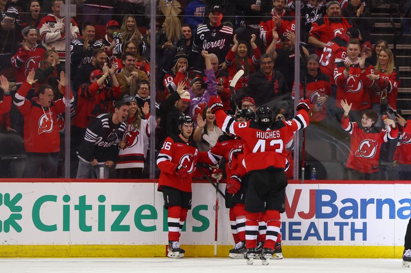 Mar 21, 2024; Newark, New Jersey, USA; New Jersey Devils center Nico Hischier (13) celebrates his goal against the Winnipeg Jets during the third period at Prudential Center. Mandatory Credit: Ed Mulholland-USA TODAY Sports