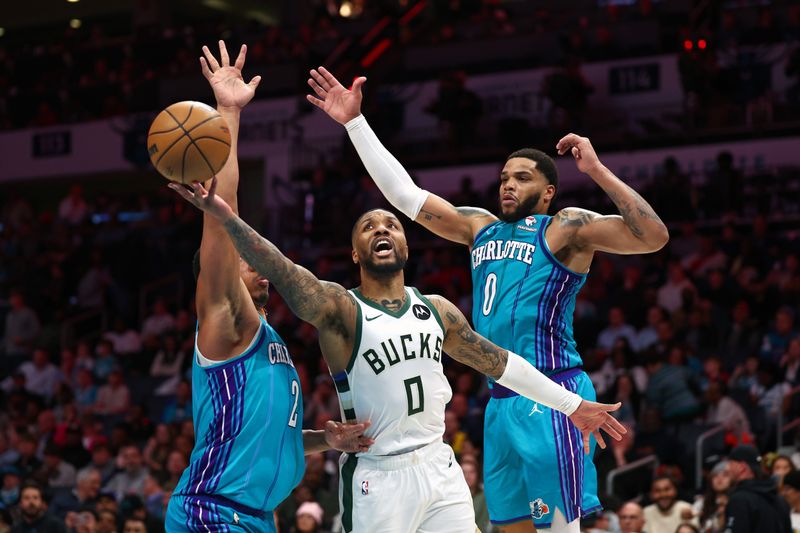 CHARLOTTE, NORTH CAROLINA - FEBRUARY 29: Damian Lillard #0 of the Milwaukee Bucks drives to the basket against Grant Williams #2 and Miles Bridges #0 of the Charlotte Hornets during the second half of the game at Spectrum Center on February 29, 2024 in Charlotte, North Carolina. NOTE TO USER: User expressly acknowledges and agrees that, by downloading and or using this photograph, User is consenting to the terms and conditions of the Getty Images License Agreement. (Photo by Jared C. Tilton/Getty Images)