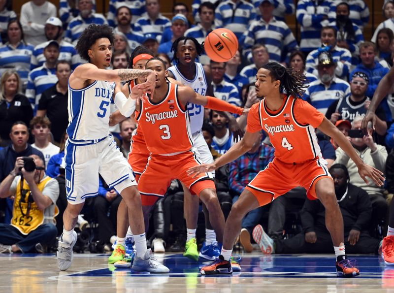 Jan 2, 2024; Durham, North Carolina, USA;  Duke Blue Devils guard Tyrese Proctor (5) throws a pass as Syracuse Orange forward Chris Bell (4) and guard Judah Mintz (3) defend during the first half at Cameron Indoor Stadium. Mandatory Credit: Rob Kinnan-USA TODAY Sports