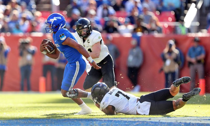 Nov 4, 2023; Denver, Colorado, USA; Air Force Falcons quarterback Zac Larrier (9) is pulled down by Army Black Knights linebacker Jimmy Ciarlo (7) during the second half at Empower Field at Mile High. Mandatory Credit: Danny Wild-USA TODAY Sports