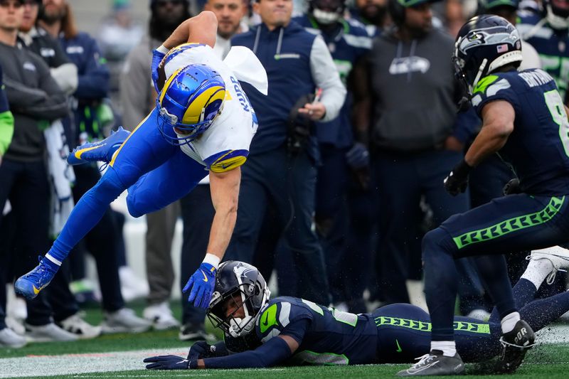 Los Angeles Rams wide receiver Cooper Kupp, foreground left, is tackled by Seattle Seahawks cornerback Josh Jobe, bottom, during the first half of an NFL football game in Seattle, Sunday, Nov. 3, 2024. (AP Photo/Lindsey Wasson)