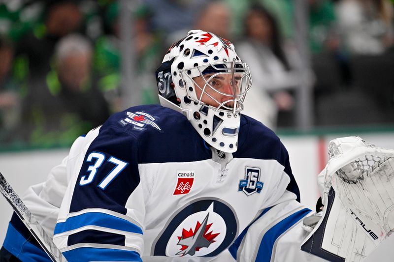 Feb 2, 2026; Dallas, Texas, USA; Winnipeg Jets goaltender Connor Hellebuyck (37) faces the Dallas Stars attack during the second period at the American Airlines Center. Mandatory Credit: Jerome Miron-Imagn Images